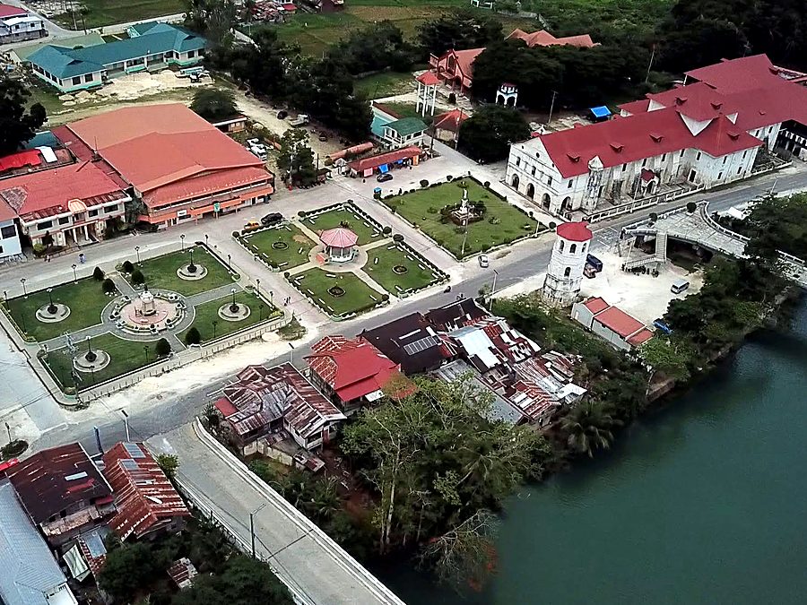 Aerial view of the Loboc town plaza and heritage church beside the river
